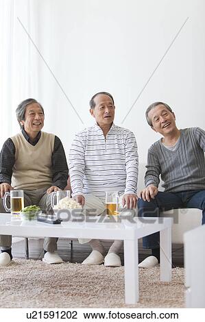Three Men Watching TV and Having Beer View Large Photo Image Stock Image - Three Men Watching TV and Having Beer. Fotosearch