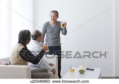 Stock Image - Three Senior Men Having Beer. Fotosearch