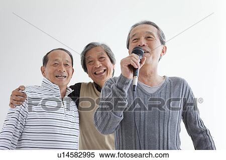 Stock Photography - Three Senior Men Singing Karaoke. Fotosearch