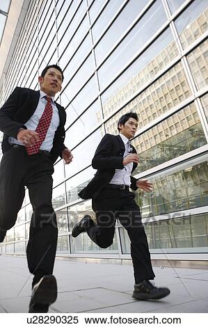 Stock Photography - Two Businessmen Running. Fotosearch