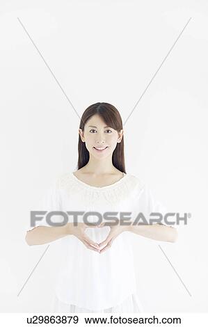 Stock Photo - Woman Forming Love Heart With Fingers. Fotosearch
