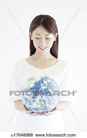 Stock Photo - Woman Holding The Earth in Her Hands. Fotosearch