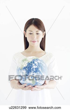 Stock Photo - Woman Holding The Earth in Her Hands. Fotosearch