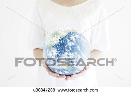 Stock Photo - Woman Holding The Earth in Her Hands. Fotosearch
