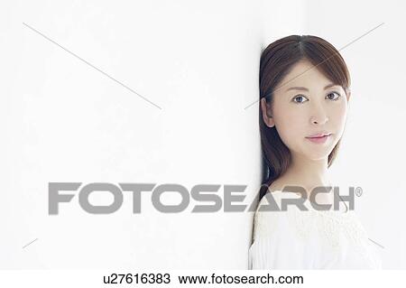 Stock Image - Woman Leaning Against Wall. Fotosearch