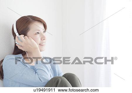 Woman Listening Music Through Headphones View Large Photo Image Stock Image - Woman Listening Music Through Headphones. Fotosearch