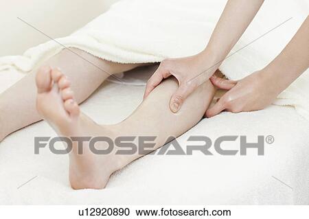 Stock Image - Woman Receiving Foot Massage. Fotosearch