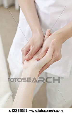 Stock Photo - Woman Receiving Hand Massage. Fotosearch