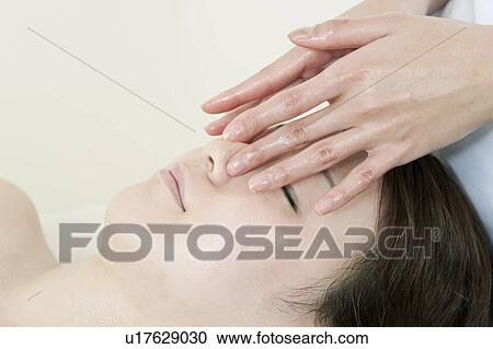 Stock Image - Woman Receiving Head Massage. Fotosearch