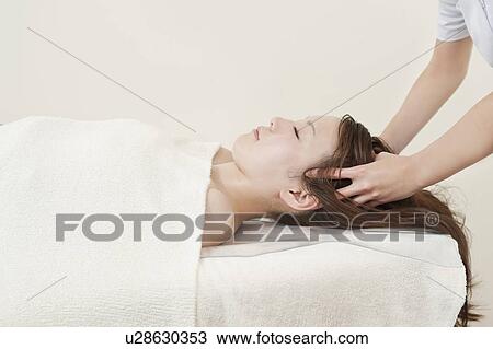 Stock Image - Woman Receiving Head Massage. Fotosearch