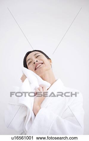 Stock Image - Woman wiping face with towel. Fotosearch