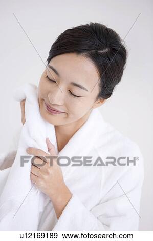 Woman wiping face with towel View Large Photo Image Stock Photo - Woman wiping face with towel. Fotosearch