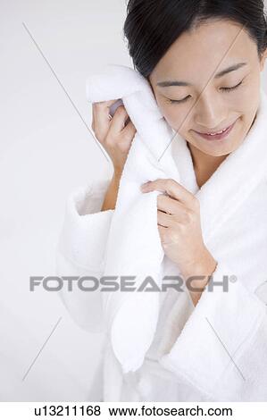 Stock Photo - Woman wiping face with towel. Fotosearch