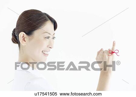 Stock Photography - Woman with Red Thread Tied Around Her Finger. Fotosearch