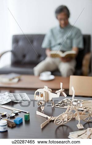 Wooden Models on Desk, Man in Background View Large Photo Image Stock Photography - Wooden Models on Desk, Man in Background. Fotosearch