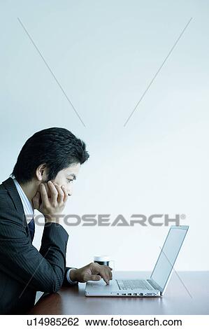 Young Businessman Using Laptop View Large Photo Image Stock Image - Young Businessman Using Laptop. Fotosearch