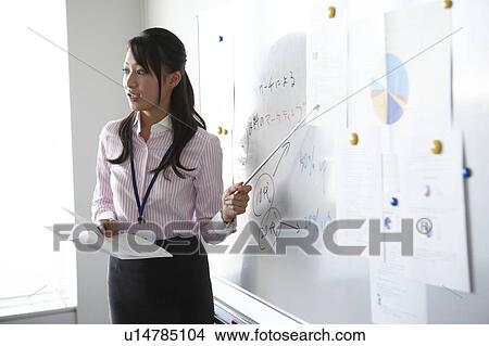 Picture - Young Businesswoman Giving Presentation. Fotosearch