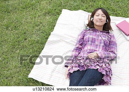 Picture - Young College Student Listening to Headphones. Fotosearch