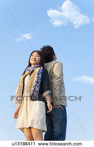 Young Couple Back to Back Against Blue Sky View Large Photo Image Stock Image - Young Couple Back to Back Against Blue Sky. Fotosearch