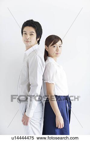 Stock Photography - Young Couple Back To Back. Fotosearch