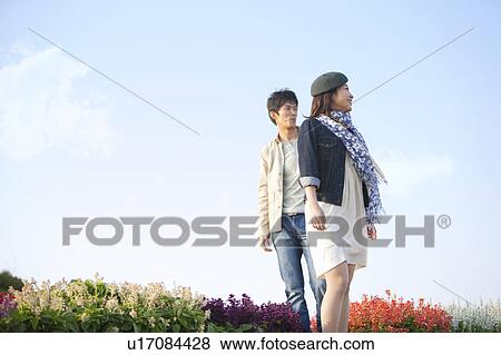 Young Couple in Field of Flowers View Large Photo Image Stock Photo - Young Couple in Field of Flowers. Fotosearch