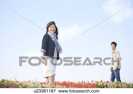 Stock Photo - Young Couple in Field of Flowers. Fotosearch