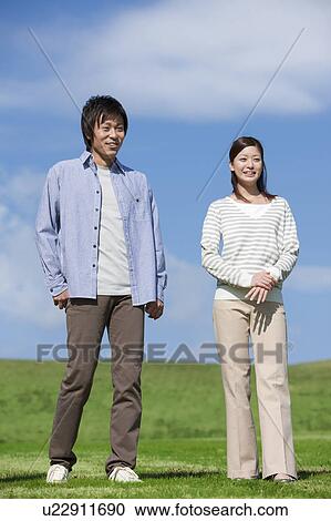 Stock Image - Young Couple in Field. Fotosearch