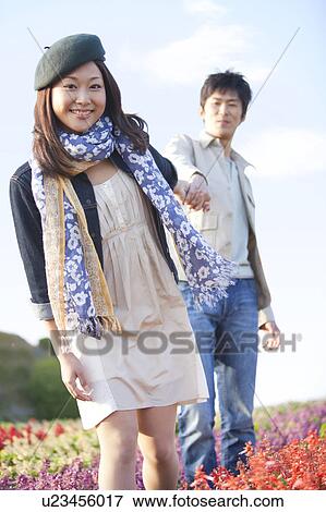 Stock Photo - Young Couple in Flower Field. Fotosearch