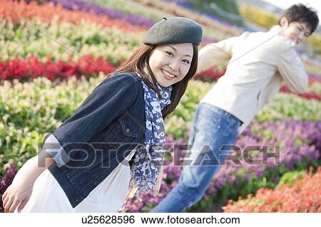 Young Couple in Flower Field View Large Photo Image Stock Photograph - Young Couple in Flower Field. Fotosearch