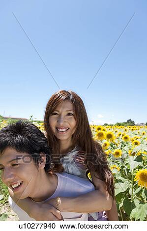 Young Couple in Sunflower Field View Large Photo Image Stock Image - Young Couple in Sunflower Field. Fotosearch