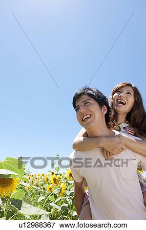 Young Couple in Sunflower Field View Large Photo Image Stock Photo - Young Couple in Sunflower Field. Fotosearch