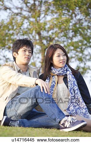 Young Couple Sitting Outdoors View Large Photo Image Stock Photography - Young Couple Sitting Outdoors. Fotosearch