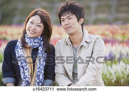 Stock Image - Young Couple Sitting. Fotosearch