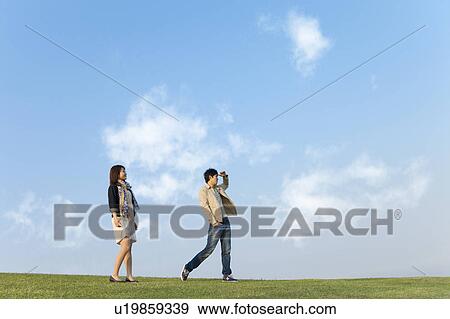 Young Couple Standing in Field View Large Photo Image Stock Photo - Young Couple Standing in Field. Fotosearch