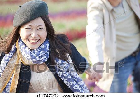 Young Couple Walking Hand in Hand View Large Photo Image Stock Image - Young Couple Walking Hand in Hand. Fotosearch