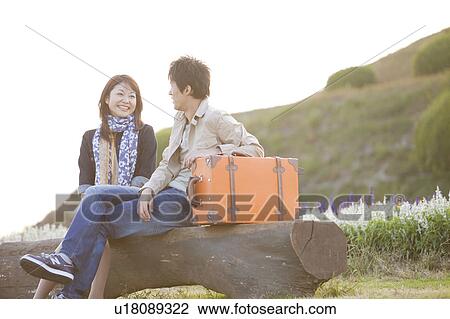 Young Couple with Luggage Sitting on Bench View Large Photo Image Stock Image - Young Couple with Luggage Sitting on Bench. Fotosearch