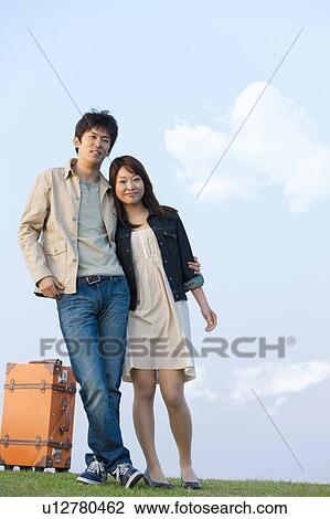 Young Couple with Suitcase Against Blue Sky View Large Photo Image Stock Image - Young Couple with Suitcase Against Blue Sky. Fotosearch