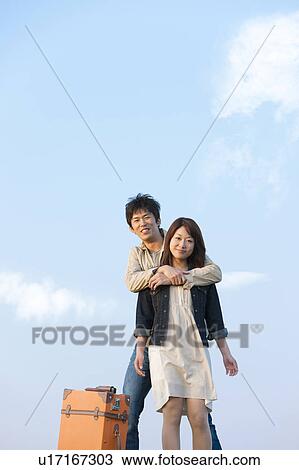 Young Couple with Suitcase Against Blue Sky View Large Photo Image Stock Image - Young Couple with Suitcase Against Blue Sky. Fotosearch