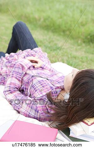 Stock Photography - Young Female College Student Listening to Music. Fotosearch