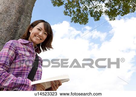 Young Female Student Below Tree View Large Photo Image Stock Image - Young Female Student Below Tree. Fotosearch