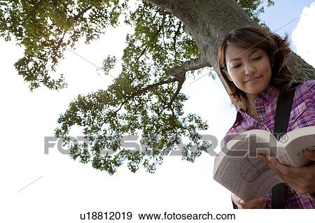 Stock Photo - Young Female Student Below Tree. Fotosearch