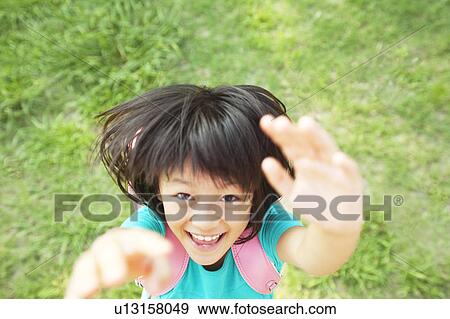 Stock Photo - Young Girl Jumping and Reaching for Camera. Fotosearch