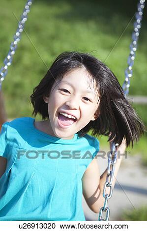 Stock Image - Young Girl on Swing. Fotosearch