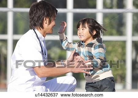 Stock Photo - Young Male Doctor and Boy. Fotosearch