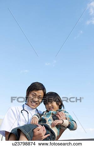 Picture - Young Male Doctor and Child. Fotosearch