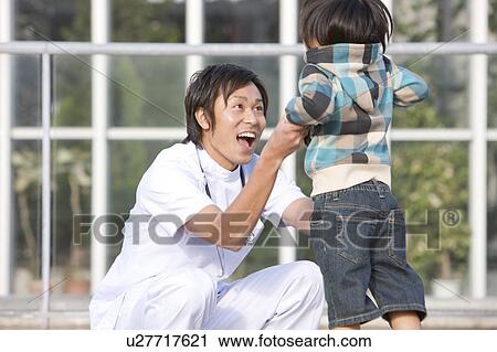 Stock Image - Young Male Doctor and Child. Fotosearch
