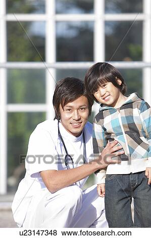Young Male Doctor and Child View Large Photo Image Stock Photo - Young Male Doctor and Child. Fotosearch