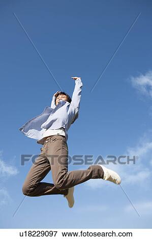 Young Man Jumping Mid Air View Large Photo Image Stock Photo - Young Man Jumping Mid Air. Fotosearch