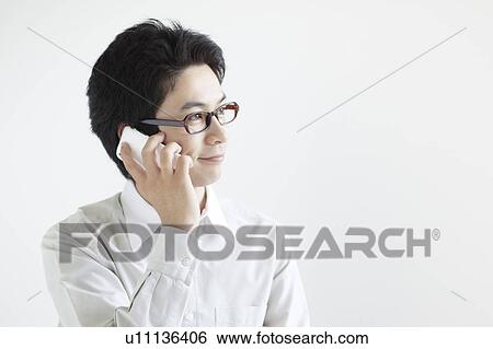Stock Photograph - Young Man On The Phone. Fotosearch