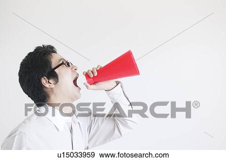 Young Man Shouting Into Megaphone View Large Photo Image Stock Photo - Young Man Shouting Into Megaphone. Fotosearch